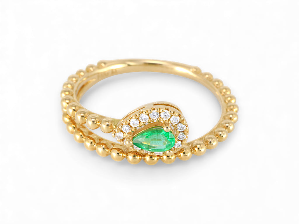 Gold ring with a green gemstone on a white background