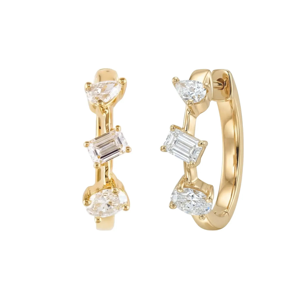 A pair of 14K Yellow Gold Huggie Hoop Earrings featuring a contemporary geometric design with an assortment of pear, baguette, and oval cut diamonds.