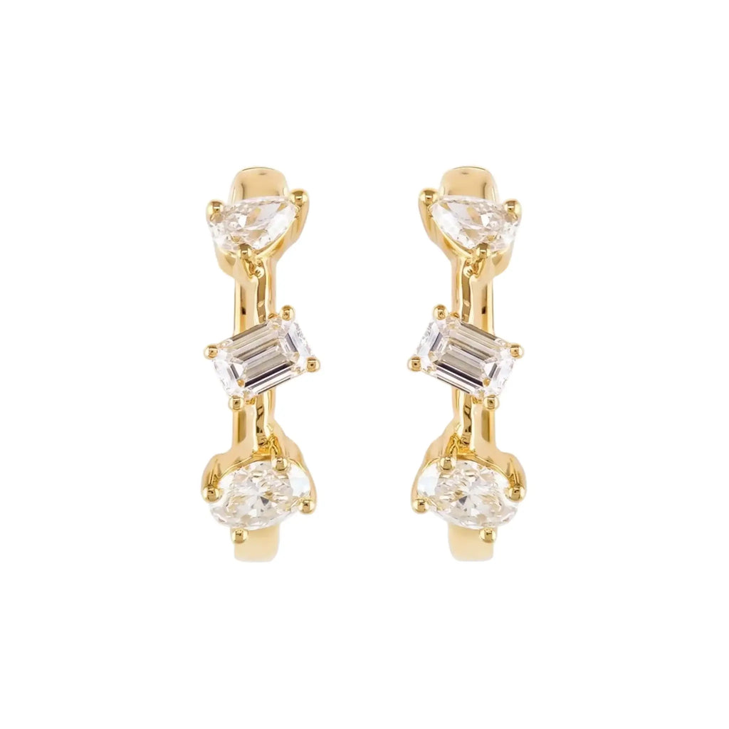 A pair of 14K Yellow Gold Huggie Hoop Earrings featuring a contemporary geometric design with an assortment of pear, baguette, and oval cut diamonds.