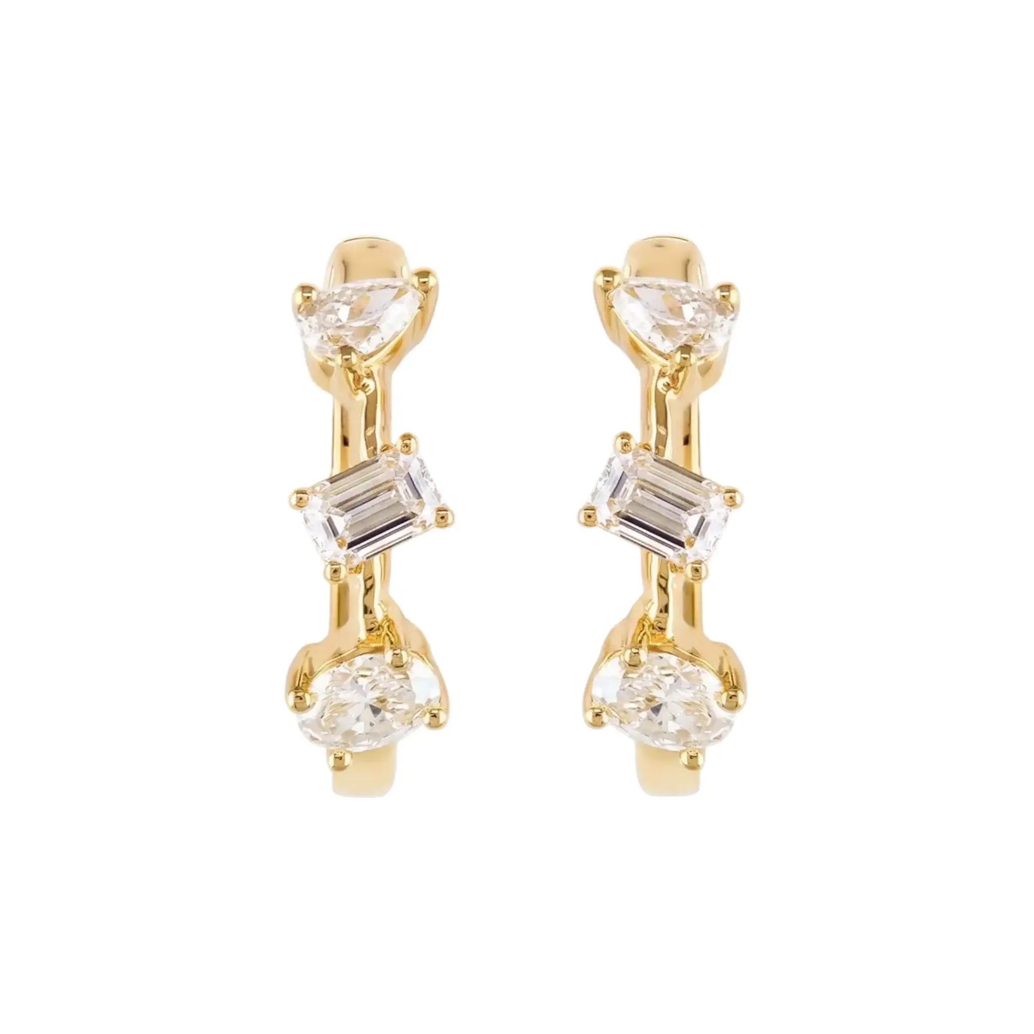 A pair of 14K Yellow Gold Huggie Hoop Earrings featuring a contemporary geometric design with an assortment of pear, baguette, and oval cut diamonds.