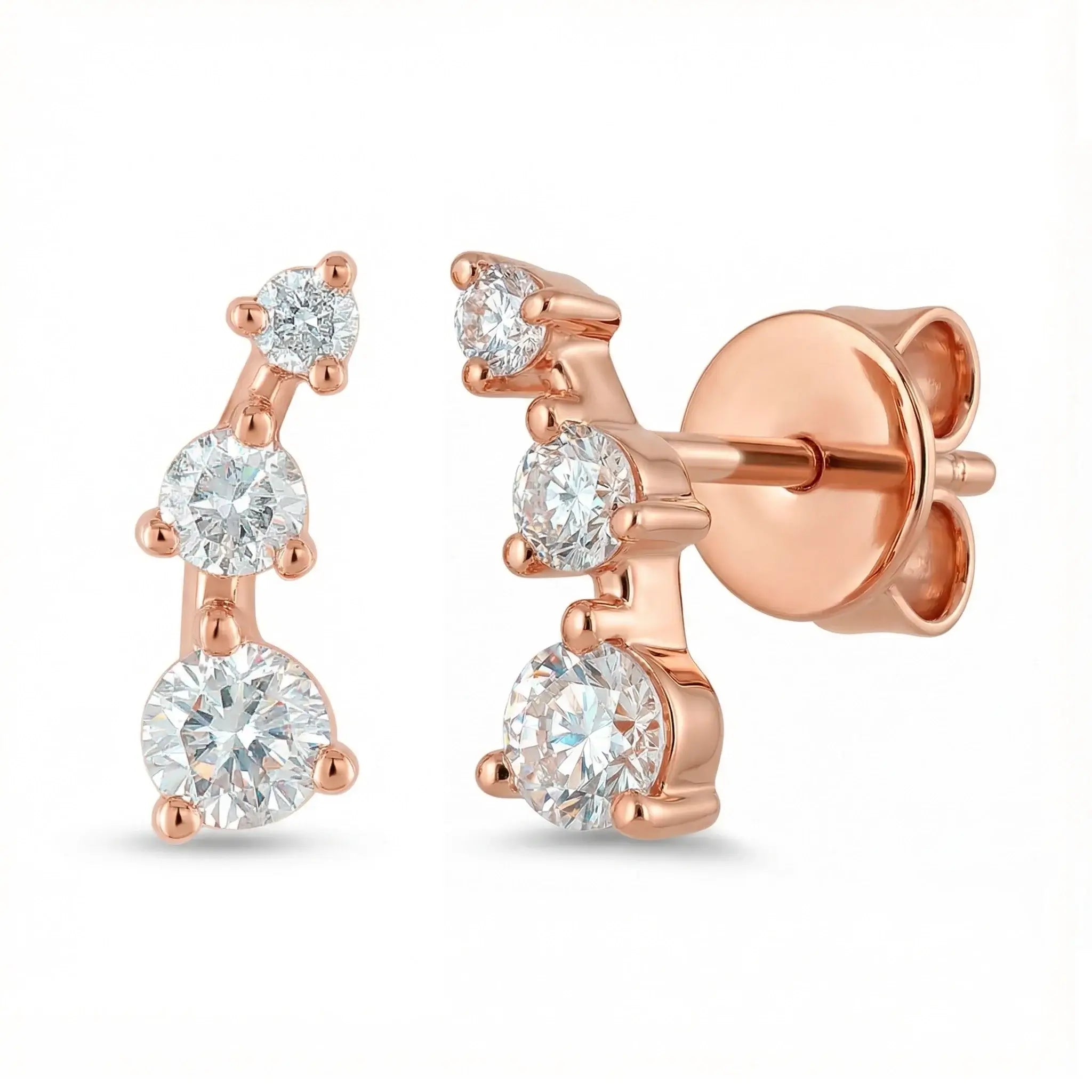 A sleek 14K Rose gold ear crawler earring, featuring three round brilliant diamonds set in a straight, minimalist line that ascends the earlobe.