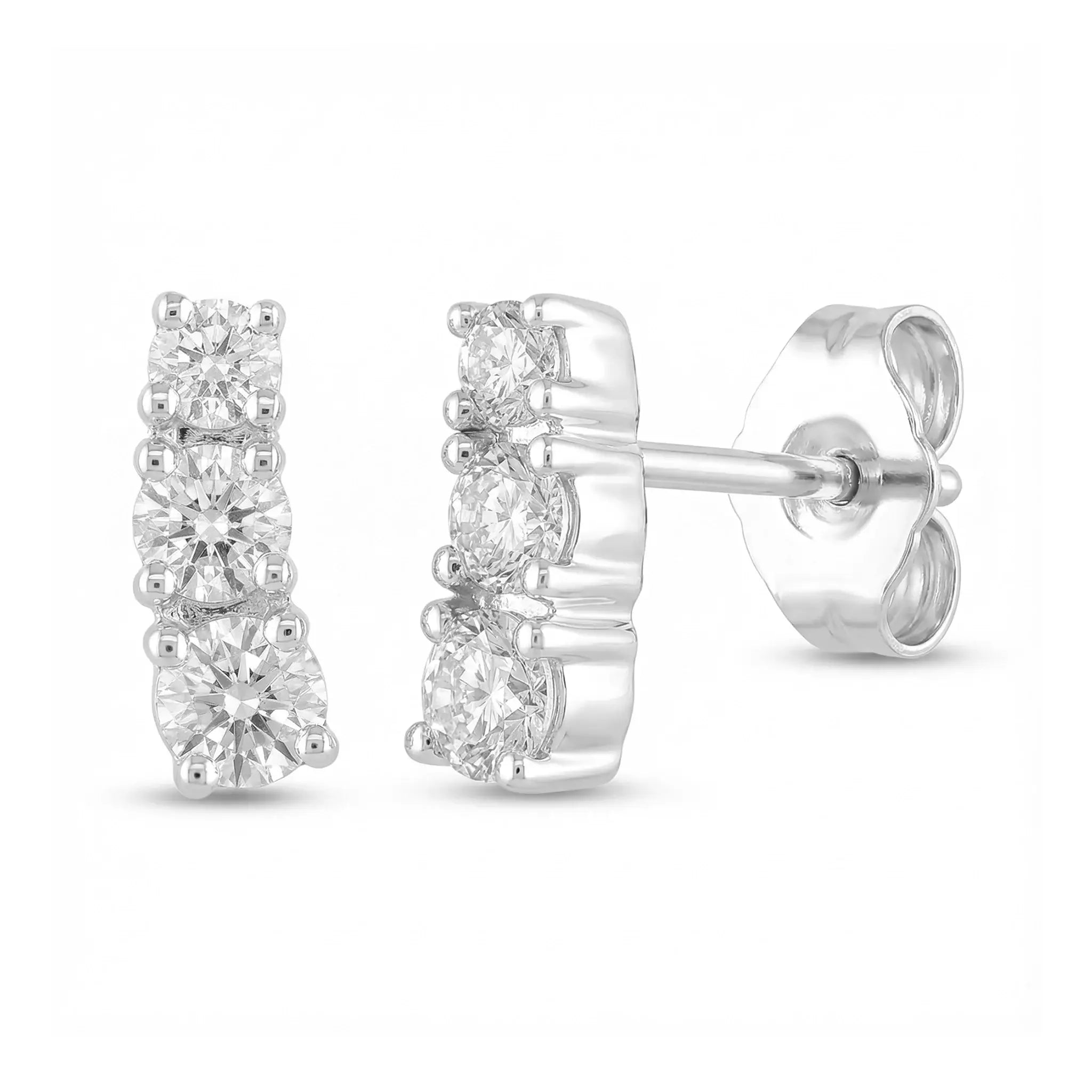 A pair of classic 14K white gold stud earrings, each featuring three round brilliant diamonds set in a horizontal row, symbolizing timeless elegance.