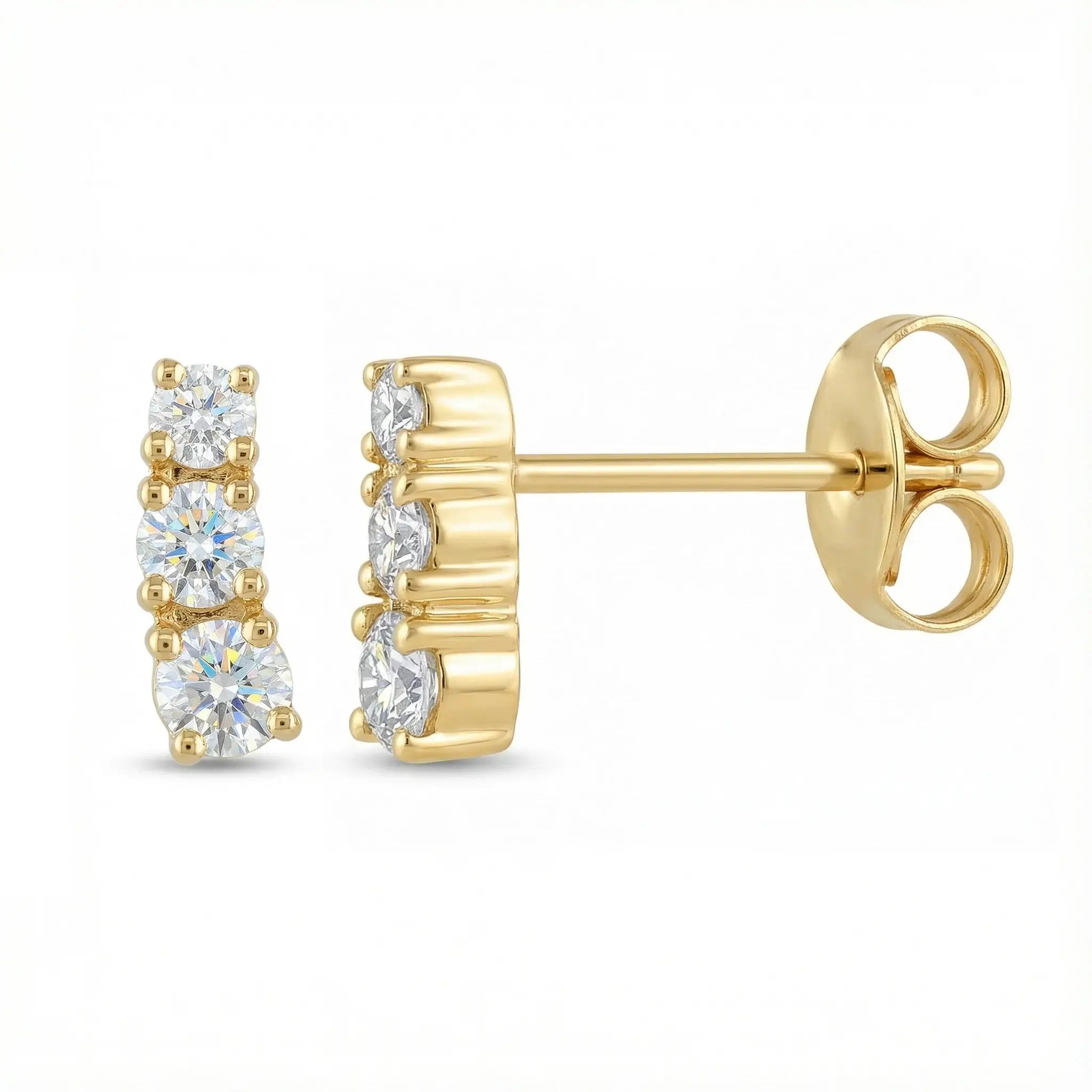 A pair of classic 14K yellow gold stud earrings, each featuring three round brilliant diamonds set in a horizontal row, symbolizing timeless elegance.