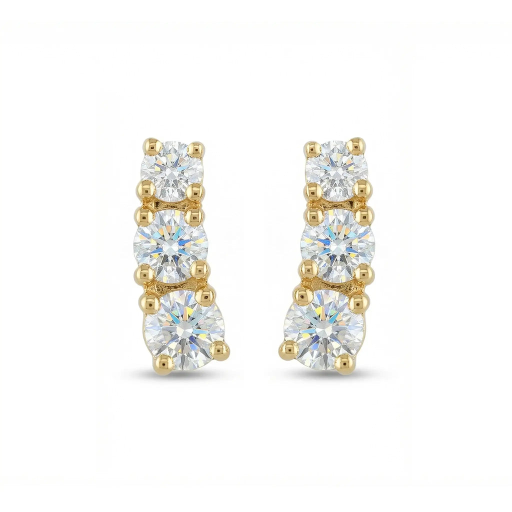 A pair of classic 14K yellow gold stud earrings, each featuring three round brilliant diamonds set in a horizontal row, symbolizing timeless elegance.