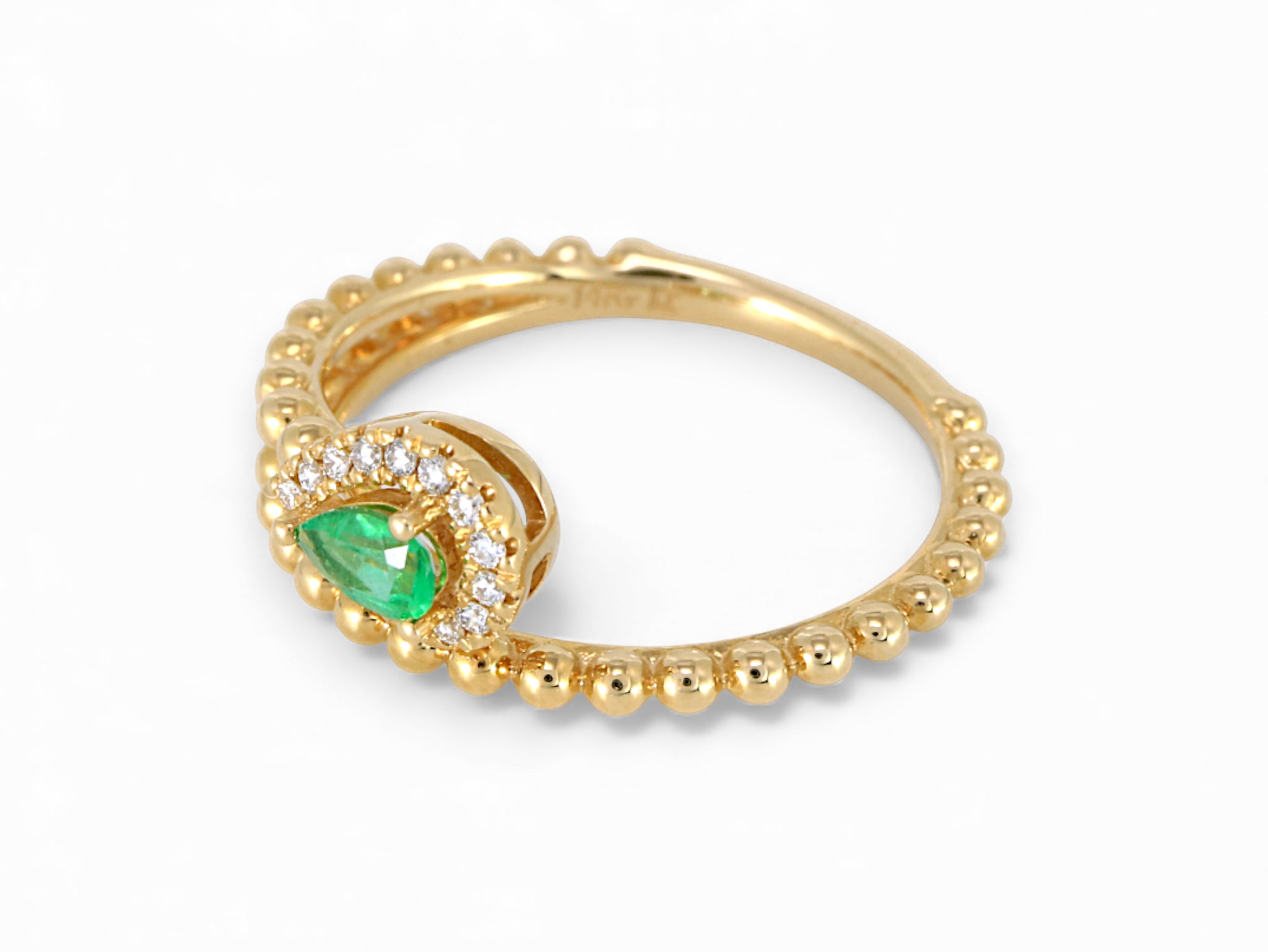 Gold ring with a green gemstone on a white background