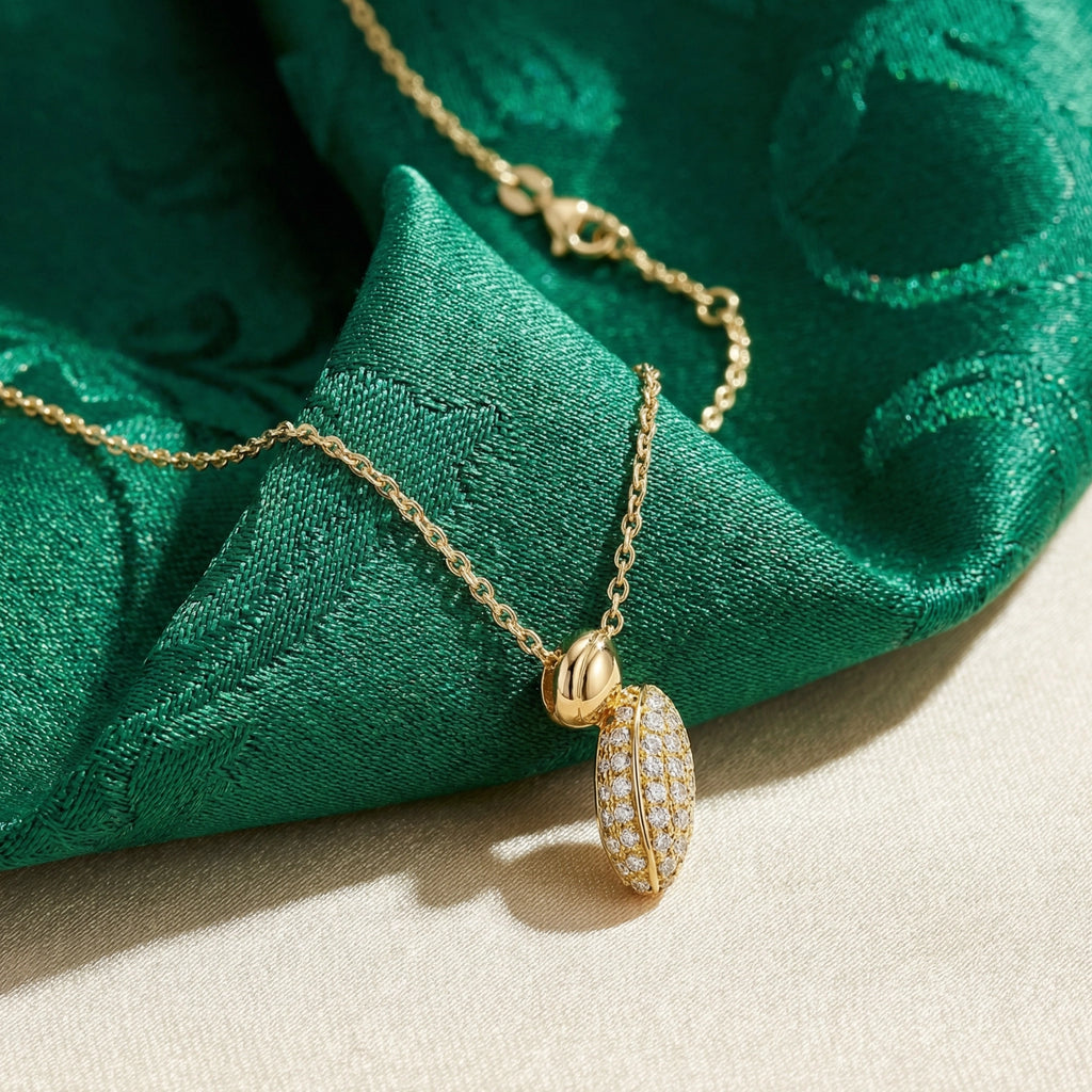 Gold necklace with a pendant on green fabric