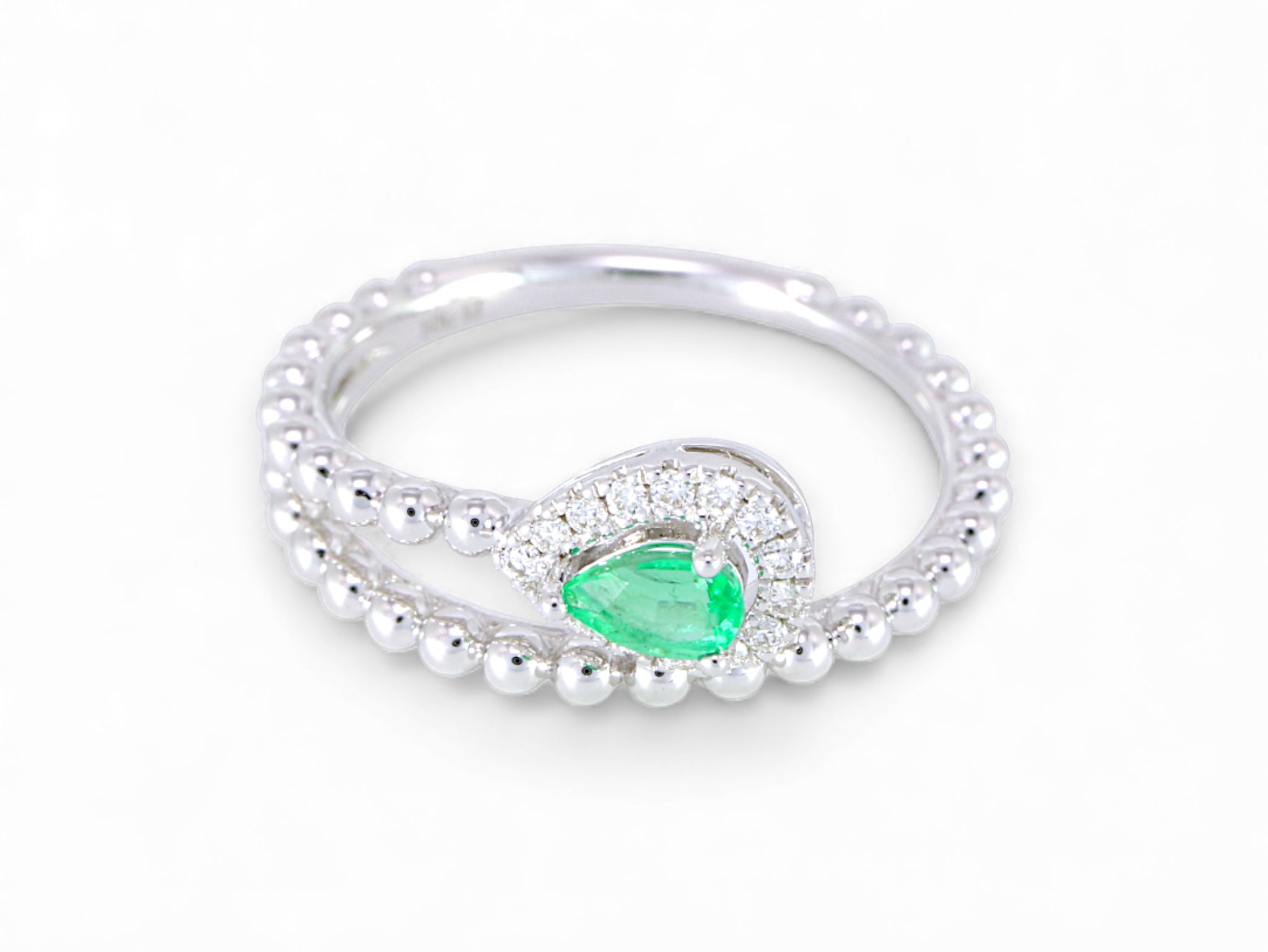 White Gold ring with a green gemstone on a white background