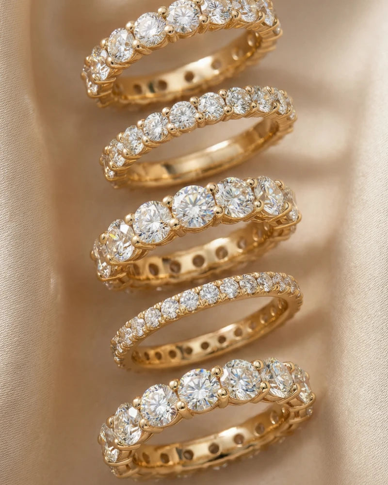 Gold spiral ring with diamonds on a beige background